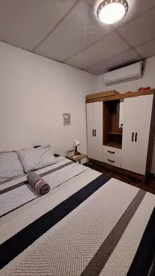 a bedroom with two beds and a light on the ceiling at Hidden House in Santa Ana
