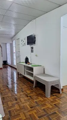 a room with a bench and a tv on a wall at Hidden House in Santa Ana