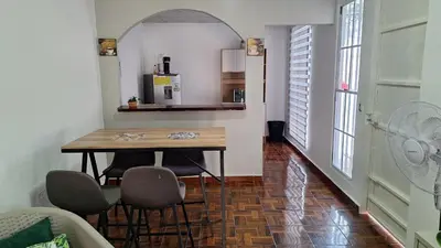 a kitchen with a table and chairs in a room at Hidden House in Santa Ana