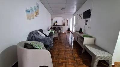a living room with two couches and a kitchen at Hidden House in Santa Ana