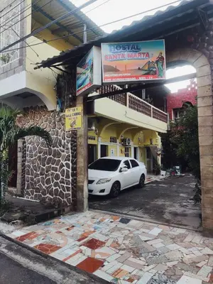 a white car parked in front of a building at Hostal Santa Marta in La Unión