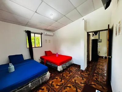a room with two beds in a room at LA CASONA SV Hostal in La Libertad