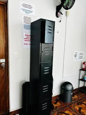 a black filing cabinet next to a wall at LA CASONA SV Hostal in La Libertad