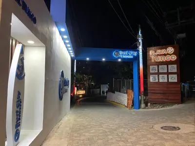 a gas station at night with a sign on it at Hostal Camila’s in Tamanique