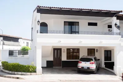 a car parked in front of a white house at House in San Miguel, Res. San Andres in San Miguel