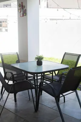 a black table with chairs and a potted plant on it at House in San Miguel, Res. San Andres in San Miguel