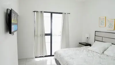 a bedroom with a bed and a large window at House in San Miguel, Res. San Andres in San Miguel