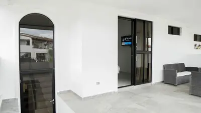 an entrance to a building with glass doors at House in San Miguel, Res. San Andres in San Miguel