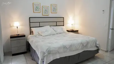 a bedroom with a large bed with two night stands at House in San Miguel, Res. San Andres in San Miguel