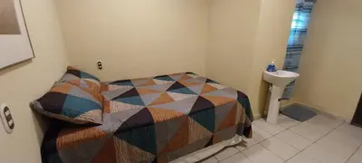 a small bedroom with a bed and a sink at Hostal San José in La Unión