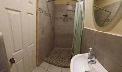 a bathroom with a shower and a sink at Hostal San José in La Unión