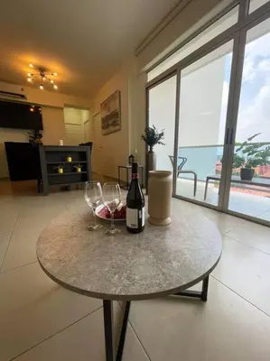 a table with two glasses and a bottle of wine at Encanto Urbano in San Salvador