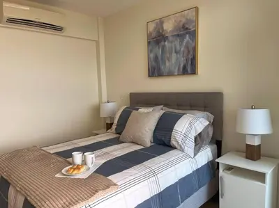 a bedroom with a bed with a tray of food on it at Encanto Urbano in San Salvador