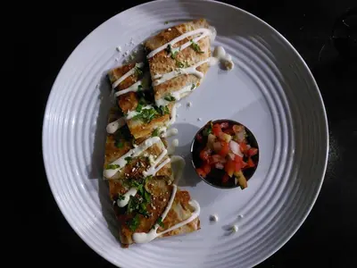 a white plate with two slices of food on it at KaiBlue Hotel y Restaurante in La Libertad