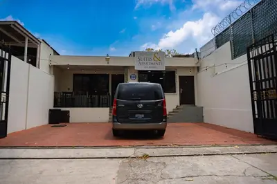 a van parked in front of a building at Hotel La Capilla - Suites & Apartments San Benito in San Salvador
