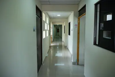 an empty corridor of a hospital with a hallway at Hotel La Capilla - Suites & Apartments San Benito in San Salvador