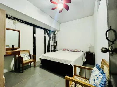 a bedroom with a bed and a table and chairs at Entre tejas in Concepción de Ataco