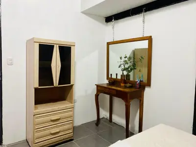 a bedroom with a mirror and a wooden dresser at Entre tejas in Concepción de Ataco