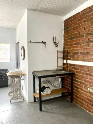 a black table in a room with a brick wall at Entre tejas in Concepción de Ataco
