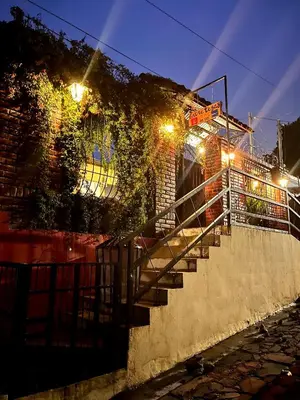 a set of stairs leading up to a building at night at Entre tejas in Concepción de Ataco