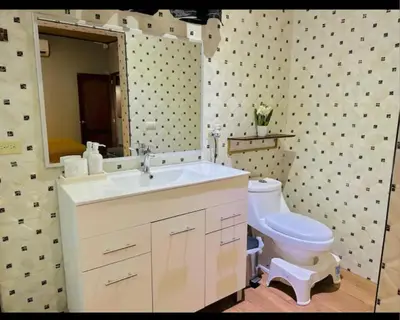 a bathroom with a white sink and a toilet at Enjoy Your Vacation at Tone'y House in Chalchuapa