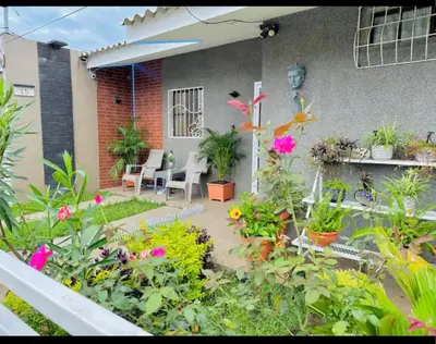 a garden with flowers and plants in front of a building at Enjoy Your Vacation at Tone'y House in Chalchuapa
