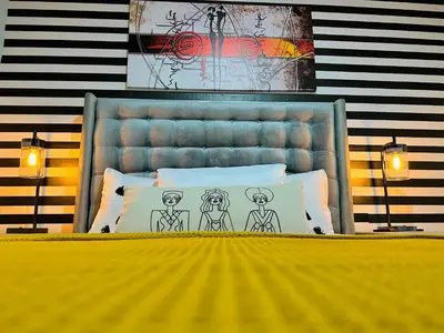 a bedroom with a bed with a bed frame and two lamps at Enjoy Your Vacation at Tone'y House in Chalchuapa