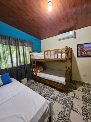 a room with two bunk beds and a window at El Patio de Don Moncho - Shalpa in Jicalapa