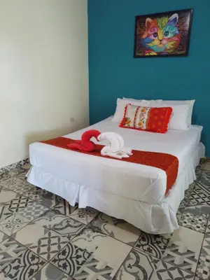 a bed with two stuffed animals on it in a room at El Patio de Don Moncho - Shalpa in Jicalapa