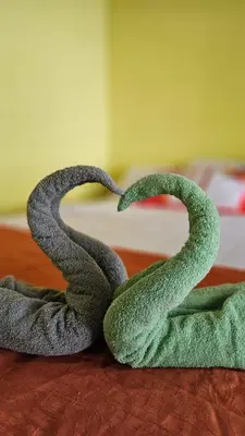 two towels shaped like snakes laying on a bed at El Patio de Don Moncho - Shalpa in Jicalapa