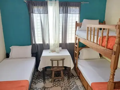 a small room with two bunk beds and a table at El Patio de Don Moncho - Shalpa in Jicalapa