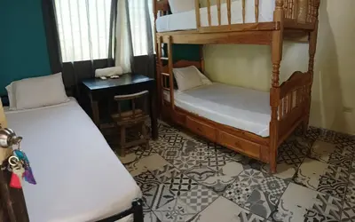 a room with two bunk beds and a table at El Patio de Don Moncho - Shalpa in Jicalapa