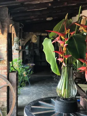 a vase filled with flowers on top of a table at Casa Degraciela - Hotel Boutique in Concepción de Ataco