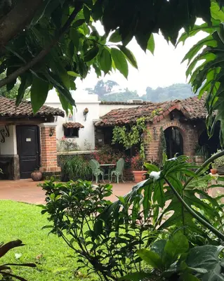 a house with a table and chairs in a yard at Casa Degraciela - Hotel Boutique in Concepción de Ataco