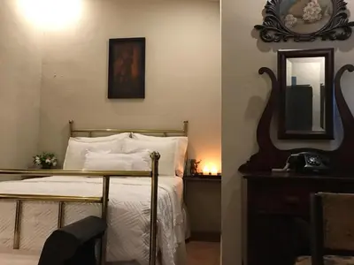 a bedroom with a bed and a mirror at Casa Degraciela - Hotel Boutique in Concepción de Ataco