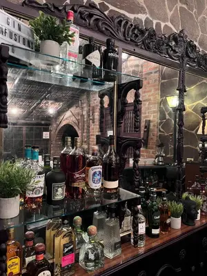 a bar with many bottles of alcohol on a shelf at Casa Degraciela - Hotel Boutique in Concepción de Ataco
