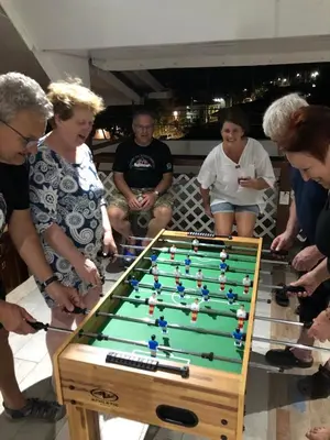 a group of people standing around a pool table at INGRID LOFTS in La Unión
