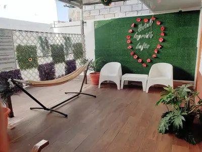 a room with two chairs and a hammock and a heart at INGRID LOFTS in La Unión