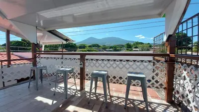 a balcony with stools and a view of the mountains at INGRID LOFTS in La Unión