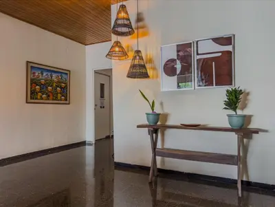 a room with a table and potted plants on the wall at Cardedeu Suites in San Salvador