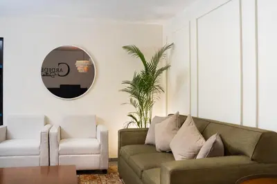 a living room with a couch and a chair at Cardedeu Suites in San Salvador