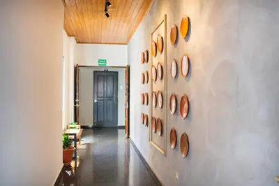 a hallway with a bunch of paintings on the wall at Cardedeu Suites in San Salvador