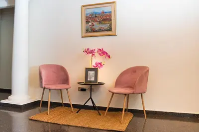 two chairs sitting next to a table with a vase at Cardedeu Suites in San Salvador