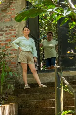 a woman standing on stairs next to a man at Hostal Delmy in Suchitoto