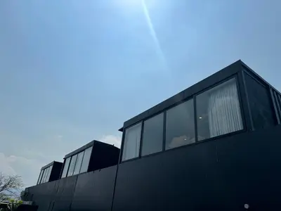 a black building with windows on the side of it at Cardedeu Hotel Lago de Coatepeque in El Congo
