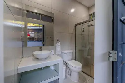 a bathroom with a toilet and a sink and a shower at San Diego Beach House, near La Lib and Surf City in La Libertad