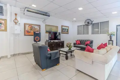 a living room with two couches and a flat screen tv at San Diego Beach House, near La Lib and Surf City in La Libertad