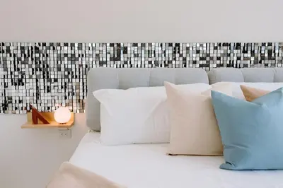 a white couch with pillows and a candle on a table at ¡Sivar Sound! Music Design! in San Salvador