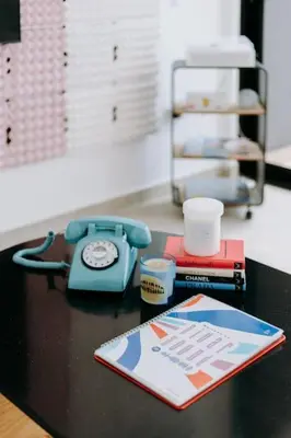 a table with a phone and a book on it at ¡Sivar Sound! Music Design! in San Salvador