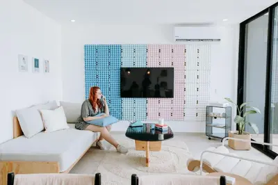 a woman sitting on a couch in a living room at ¡Sivar Sound! Music Design! in San Salvador